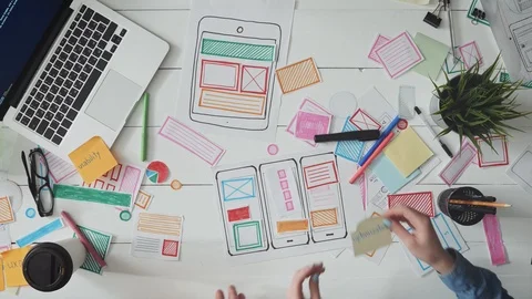 UX designers putting post it notes on app layout Stock Footage 93522829