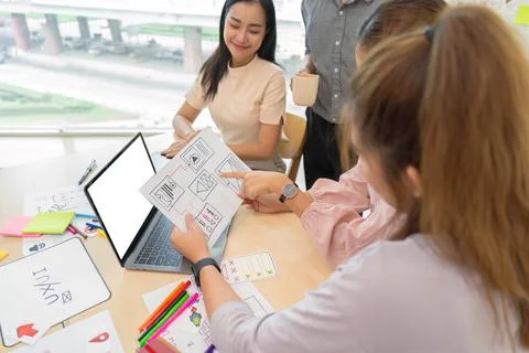Ux developer and ui designer presenting and testing mobile app interface Stock Photos