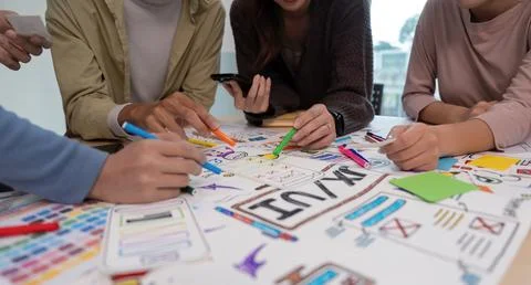 UX developer and ui designer brainstorming about mobile app interface wireframe Stock Photos