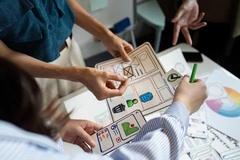 Ux developer and UI designer team brainstorm together about designing Stock Photos