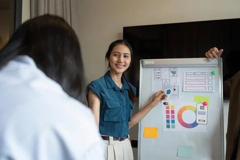 Ux developer and UI designer team brainstorm together about designing Stock Photos