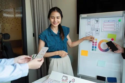 Ux developer and UI designer team brainstorm together about designing Foto stock