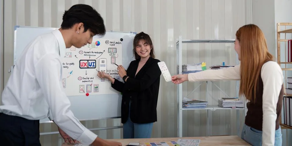 Ux developer and ui designer presenting mobile app interface design on Stock Photos