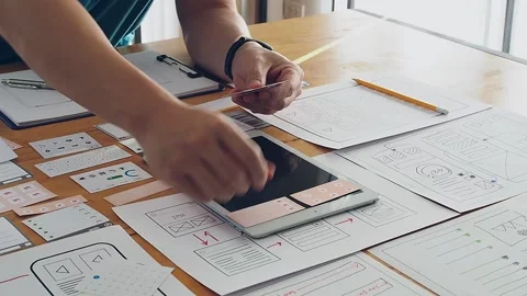 UX or UI designer designing application on tablet with mockup layout. Stock Footage 146391676