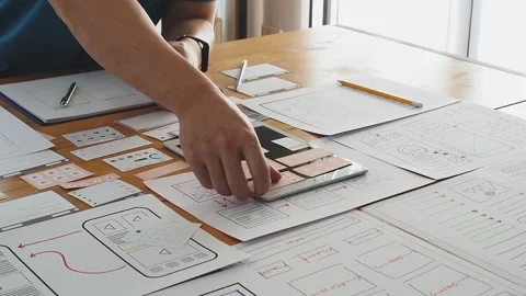 UX or UI designer designing application on tablet with mockup layout. Stock Footage 148151143