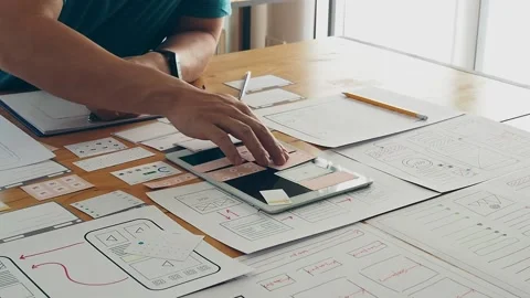 UX or UI designer designing application on tablet with layout prototype. Stock Footage 207024315