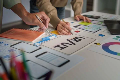 UX UI Design Collaboration. Creative team brainstorming on mobile app interface. Stock Photos