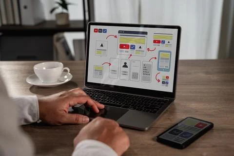 UX UI design process concept showing a designer working on a laptop with in.. 库存照片