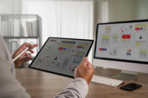 UX UI design process concept showing a designer using a tablet to work on i.. 스톡 사진