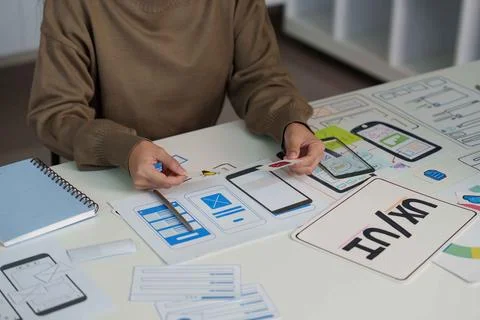 UX UI Design Process. Designer Creating Mobile App Wireframes and User Stock Photos