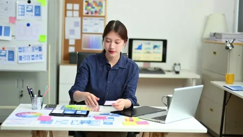 UX UI designer planning mobile layout with sticky notes in modern office. C.. Stock Footage 312437656