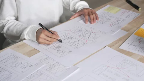 UX UI designer working on wireframes for a website and mobile app prototype Stock Footage 291554071