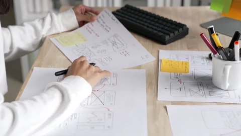 UX UI designer working on wireframes for a website and mobile app prototype Stock Footage 291554214