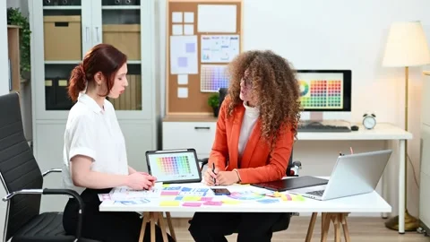 UX UI designers working with color palettes, wireframes, and digital tablet.. Vídeo Stock 312387076