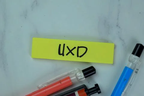 UXD - User eXperience Design write on sticky notes isolated on Wooden Table. Stock Photos