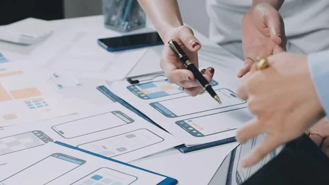UXUI design brainstorming session with sketches and digital tools Stock Footage 323348631