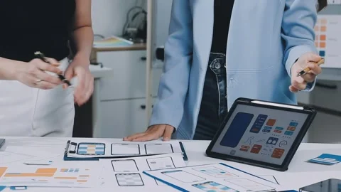 UXUI design brainstorming session with sketches and digital tools Stock Footage 323348638