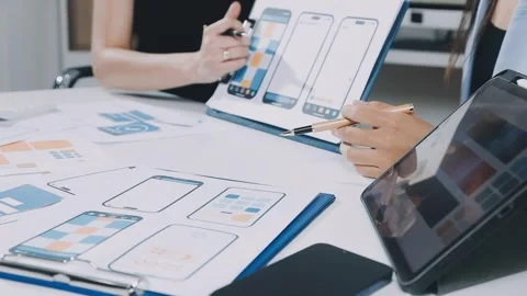 UXUI design brainstorming session with sketches and digital tools Stock Footage 323348660