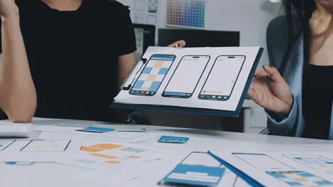 UXUI design brainstorming session with sketches and digital tools Stock Footage 323348669