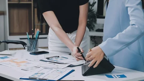 UXUI design brainstorming session with sketches and digital tools Stock Footage 323348697
