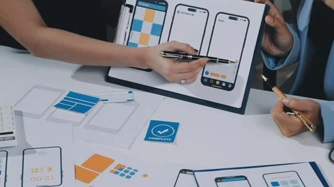 UXUI design brainstorming session with sketches and digital tools Stock Footage 323348873