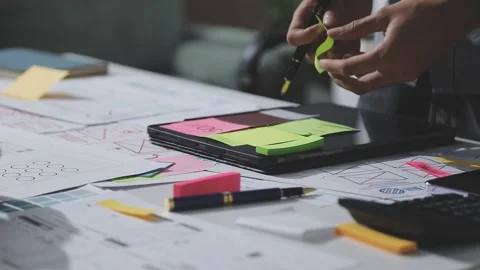 UXUI design brainstorming session with sketches and digital tools Stock Footage 324849036