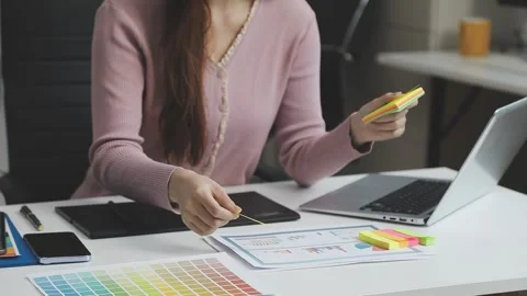 UX/UI designer working on wireframes for a website and mobile app prototype.. Stock Footage 309837159
