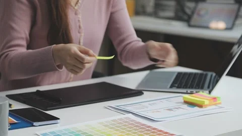 UX/UI designer working on wireframes for a website and mobile app prototype.. Stock Footage 309837161