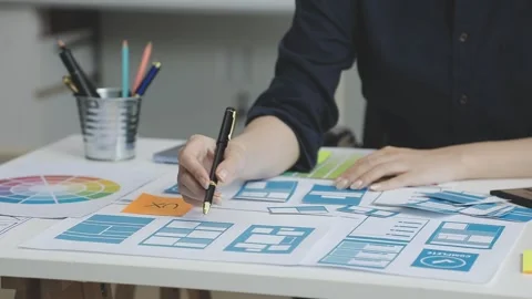 UX/UI designer working on wireframes for a website and mobile app prototype.. Stock Footage 309837457