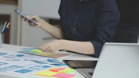 UX/UI designer working on wireframes for a website and mobile app prototype.. Stock Footage 309837461
