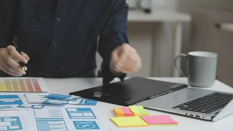 UX/UI designer working on wireframes for a website and mobile app prototype.. Stock Footage 309837471