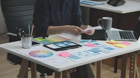 UX/UI designer working on wireframes for a website and mobile app prototype.. Stock Footage 309837477