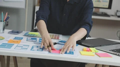 UX/UI designer working on wireframes for a website and mobile app prototype.. Stock Footage 309837481
