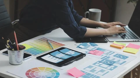 UX/UI designer working on wireframes for a website and mobile app prototype.. Stock Footage 309837487