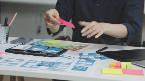 UX/UI designer working on wireframes for a website and mobile app prototype.. Stock Footage 309837507