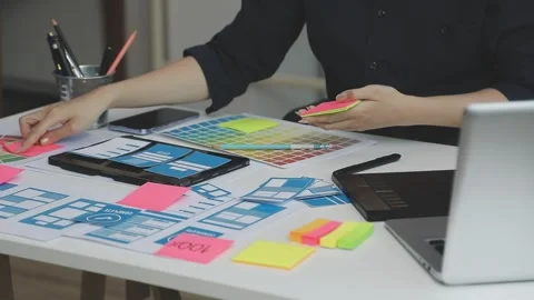 UX/UI designer working on wireframes for a website and mobile app prototype.. Stock Footage 309837509