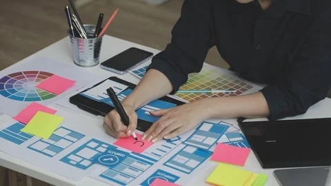 UX/UI designer working on wireframes for a website and mobile app prototype.. Stock Footage 309837519