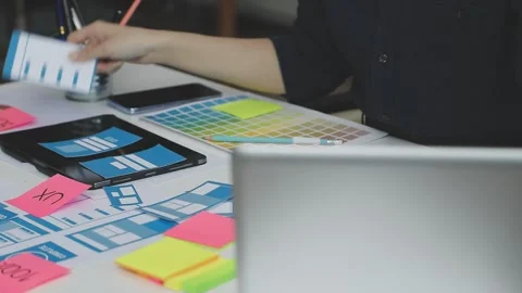 UX/UI designer working on wireframes for a website and mobile app prototype.. Stock Footage 309837523