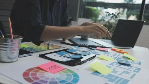 UX/UI designer working on wireframes for a website and mobile app prototype.. Stock Footage 309837571