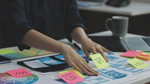 UX/UI designer working on wireframes for a website and mobile app prototype.. Stock Footage 309837578