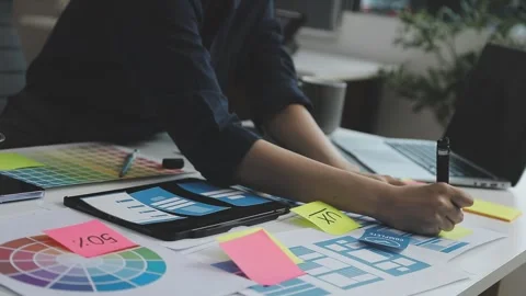 UX/UI designer working on wireframes for a website and mobile app prototype.. Stock Footage 309837580