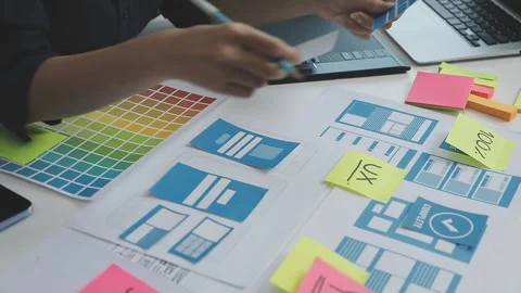 UX/UI designer working on wireframes for a website and mobile app prototype.. Stock Footage 309837584