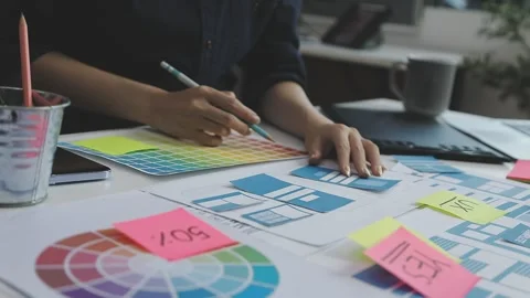 UX/UI designer working on wireframes for a website and mobile app prototype.. Stock Footage 309837586