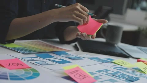 UX/UI designer working on wireframes for a website and mobile app prototype.. Stock Footage 309837600