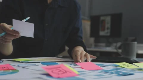 UX/UI designer working on wireframes for a website and mobile app prototype.. Stock Footage 309837611