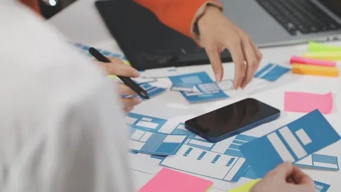 UX/UI designer working on wireframes for a website and mobile app prototype.. Stock Footage 309837634