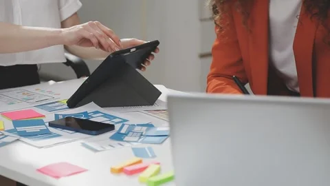 UX/UI designer working on wireframes for a website and mobile app prototype.. Stock Footage 309837640