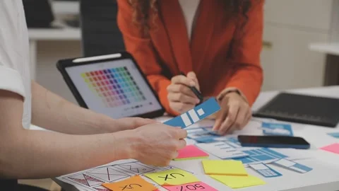 UX/UI designer working on wireframes for a website and mobile app prototype.. Stock Footage 309837647