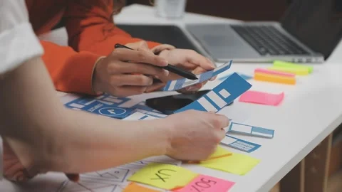 UX/UI designer working on wireframes for a website and mobile app prototype.. Stock Footage 309837648