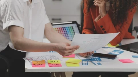 UX/UI designer working on wireframes for a website and mobile app prototype.. Stock Footage 309837649